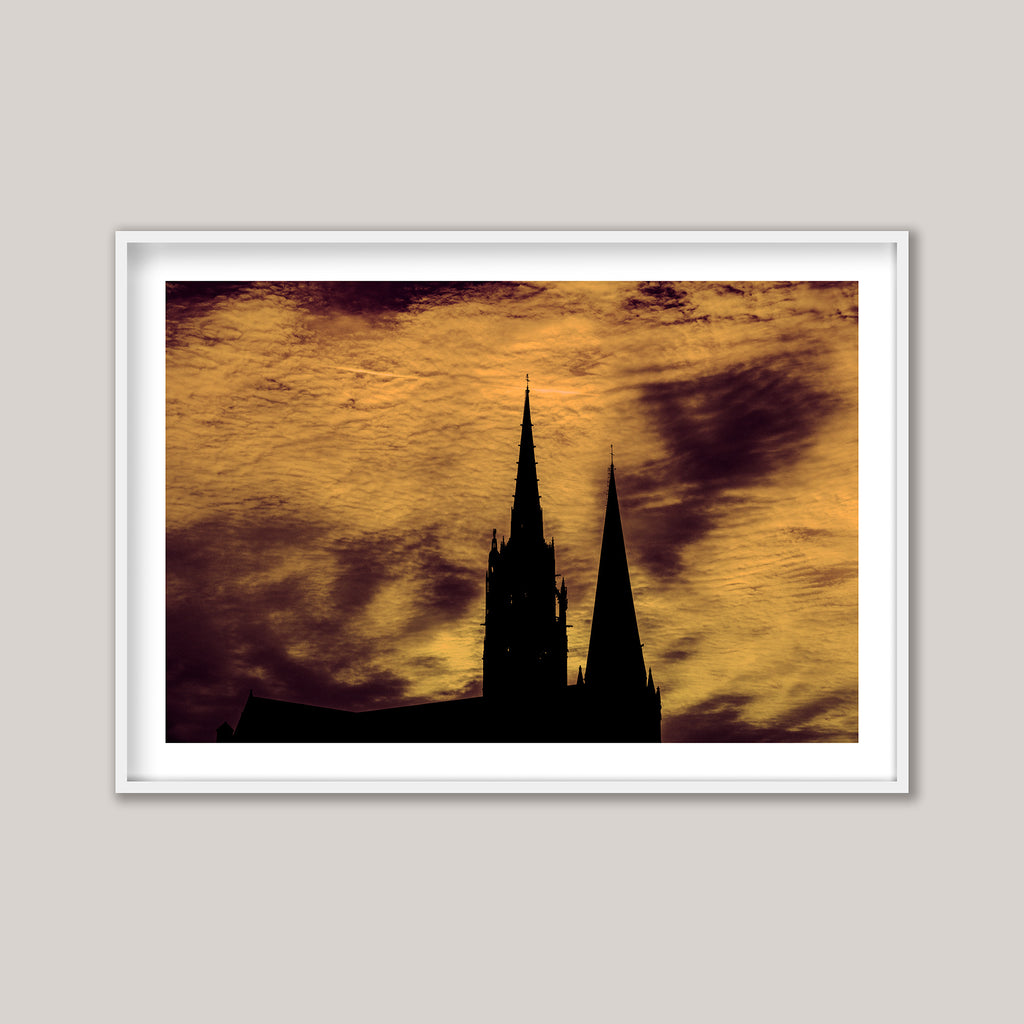 photograph of a silhouette of a cathedral against a sunset sky.