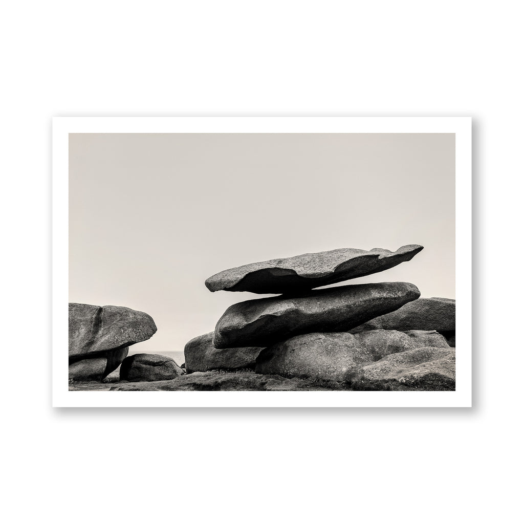 Black and white photograph of stacked stones on a plain background.
Stack of large stones against a plain background. black and white landscape photograph. Fine art photograph