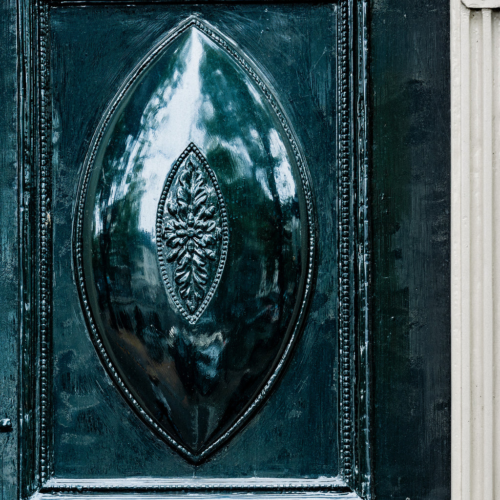 Decorative blue door in Amsterdam with intricate design