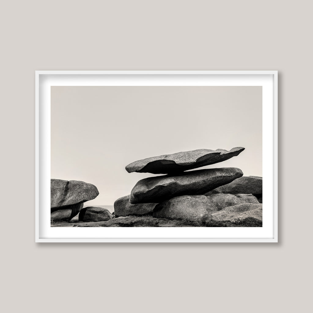 Framed black and white photograph of stacked stones on a plain background
Stack of large stones against a plain background. black and white landscape photograph. Fine art photograph