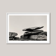 Framed black and white photograph of stacked stones on a plain background
Stack of large stones against a plain background. black and white landscape photograph. Fine art photograph