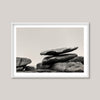 Framed black and white photograph of stacked stones on a plain background
Stack of large stones against a plain background. black and white landscape photograph. Fine art photograph