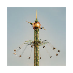 Amusement park ride with swings against a clear sky