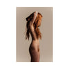 Naked person with long red hair against a beige background
